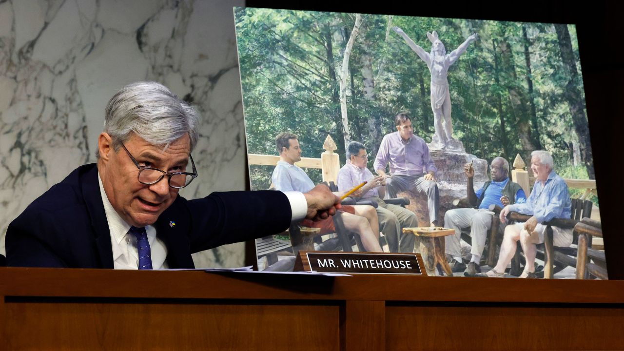 Senate Judiciary Committee member Sen. Sheldon Whitehouse displays a copy of a painting featuring Supreme Court Associate Justice Clarence Thomas alongside other conservative leaders during a hearing on Supreme Court ethics reform on Capitol Hill on May 2 in Washington, DC. 