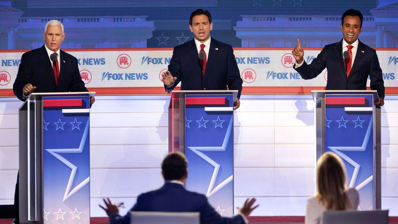 DeSantis, flanked by former Vice President Mike Pence, left, and entrepreneur Vivek Ramaswamy participate in the first GOP primary debate in Milwaukee on August 23, 2023. 
