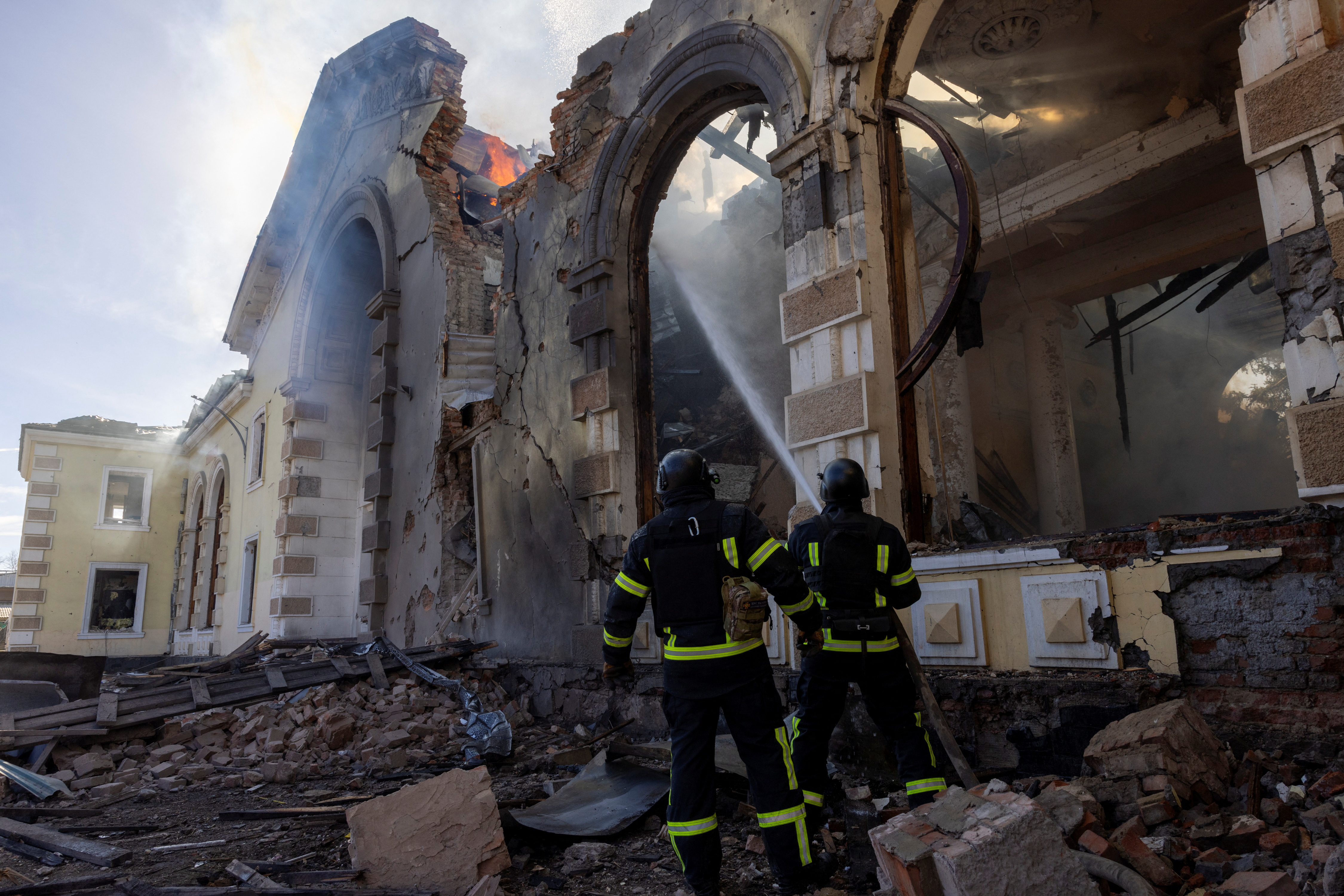 Firefighters work at the scene of a Russian missile strike that destroyed a train station in Kostiantynivka, Ukraine